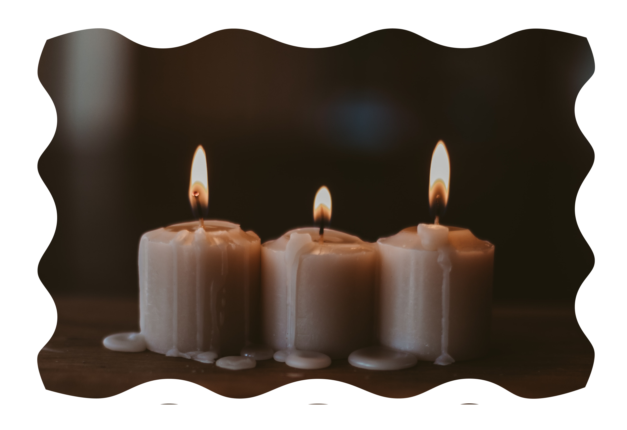 Image of white candles burning against a dark background.
